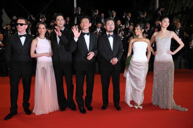 (From L) German actor Michael Fassbender, Swedish actress Alicia Vikander, South Korean actor Zo In-Sung, South korean actor Hwang Jung-Min, South Korean director and screenwriter Na Hong-Jin, Canadian actress Taylor Russell and Korean actress Ho-yeon Jung arrive for the screening of the film "Hope" at the 79th edition of the Cannes Film Festival in Cannes, southern France on May 17, 2026. (Photo by Olivier CHASSIGNOLE / AFP)