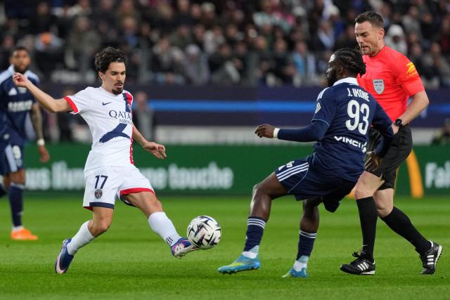 Paris Saint-Germain's Portuguese midfielder #17 Vitinha (L) and Paris FC's French midfielder #93 Jonathan Ikone (R) fight for the ball during the French L1 football match between Paris FC and Paris Saint-Germain (PSG) at the Stade Jean-Bouin in Paris on May 17, 2026. (Photo by Dimitar DILKOFF / AFP)