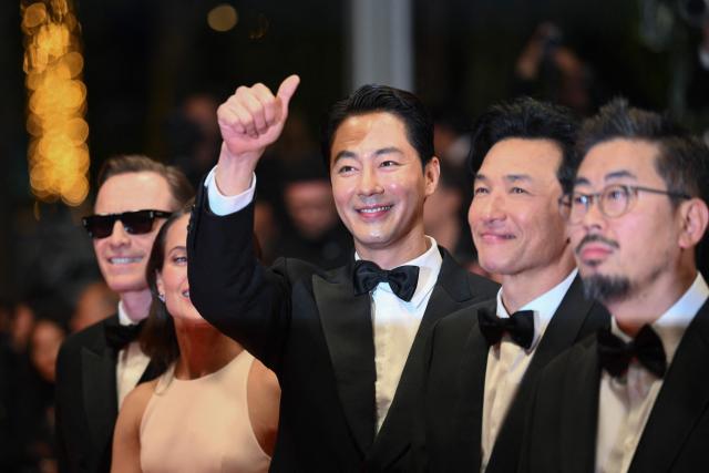 South Korean actor Zo In-Sung, South korean actor Hwang Jung-Min and South Korean director and screenwriter Na Hong-Jin arrive for the screening of the film "Hope" at the 79th edition of the Cannes Film Festival in Cannes, southern France on May 17, 2026. (Photo by Olivier CHASSIGNOLE / AFP)