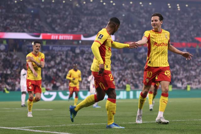 Lens' French forward #22 Wesley Said (C) celebrates with Lens' French forward #10 Florian Thauvin (R) after scoring his team's second goal during the French L1 football match between Olympique Lyonnais (OL) and RC Lens at the Groupama Stadium in Decines-Charpieu, central-eastern France, on May 17, 2026. (Photo by Alex MARTIN / AFP)