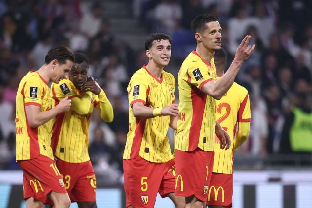 Lens' French forward #07 Florian Sotoca (R) celebrates with teammates after scoring his team's third goal during the French L1 football match between Olympique Lyonnais (OL) and RC Lens at the Groupama Stadium in Decines-Charpieu, central-eastern France, on May 17, 2026. (Photo by Alex MARTIN / AFP)