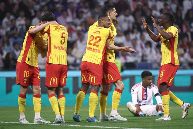 Lens' French forward #07 Florian Sotoca (2R) celebrates with teammates after scoring his team's third goal during the French L1 football match between Olympique Lyonnais (OL) and RC Lens at the Groupama Stadium in Decines-Charpieu, central-eastern France, on May 17, 2026. (Photo by Alex MARTIN / AFP)