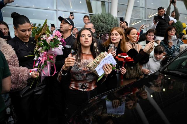 Bulgarian singer Dara receives flowers and presents from supporters upon her arrival in Sofia one day after winning the Eurovision Song Contest with her song "Bangaranga" on May 17, 2026. (Photo by Nikolay DOYCHINOV / AFP)
