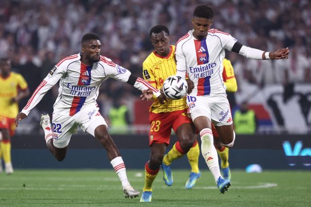 Lens' Saudi Arabian defender #23 Saud Abdulhamid (C) fights for the ball with Lyon's Angolan defender #22 Clinton Mata (L) and Lyon's Brazilian defender #16 Abner Vinicius  during the French L1 football match between Olympique Lyonnais (OL) and RC Lens at the Groupama Stadium in Decines-Charpieu, central-eastern France, on May 17, 2026. (Photo by Alex MARTIN / AFP)