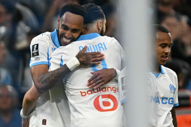 Marseille's Gabonese forward #17 Pierre-Emerick Aubameyang (L) celebrates scoring his team's third goal during the French L1 football match between Olympique de Marseille (OM) and Stade Rennais FC at the Stade Velodrome in Marseille, southern France, on May 17, 2026. (Photo by Gabriel BOUYS / AFP)