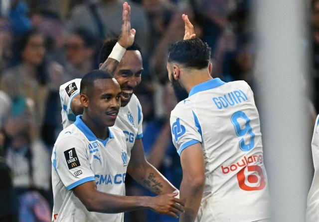 Marseille's Gabonese forward #17 Pierre-Emerick Aubameyang (2ndL) celebrates scoring his team's third goal during the French L1 football match between Olympique de Marseille (OM) and Stade Rennais FC at the Stade Velodrome in Marseille, southern France, on May 17, 2026. (Photo by Gabriel BOUYS / AFP)
