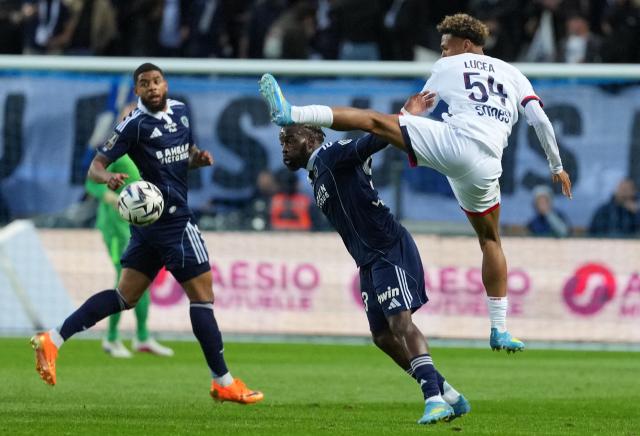 Paris FC's French midfielder #93 Jonathan Ikone (C) and Paris Saint-Germain's French defender #54 Dimitri Lucea (R) fight for the ball during the French L1 football match between Paris FC and Paris Saint-Germain (PSG) at the Stade Jean-Bouin in Paris on May 17, 2026. (Photo by Dimitar DILKOFF / AFP)