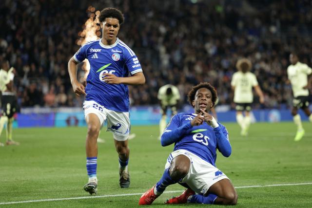 trasbourg’s Ivorian forward #20 Martial Godo (R) celebrates after scoring his team’s fifth goal during the French L1 football match between RC Strasbourg Alsace and AS Monaco at the Stade de la Meinau in Strasbourg, eastern France, on May 17, 2026. (Photo by ROMEO BOETZLE / AFP)