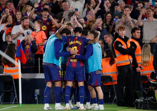 Barcelona's Portuguese defender #02 Joao Cancelo celebrates scoring his team's third goal during the Spanish league football match between FC Barcelona and Real Betis at the Camp Nou Stadium in Barcelona on May 17, 2026. (Photo by JAIME REINA / AFP)
