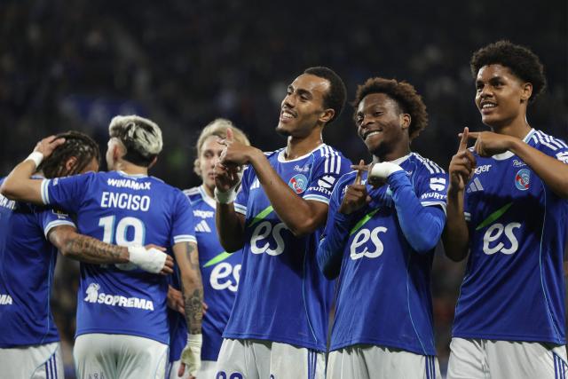 Strasbourg’s Ivorian forward #20 Martial Godo (2ndR) celebrates with teammates after scoring his team’s fifth goal during the French L1 football match between RC Strasbourg Alsace and AS Monaco at the Stade de la Meinau in Strasbourg, eastern France, on May 17, 2026. (Photo by ROMEO BOETZLE / AFP)