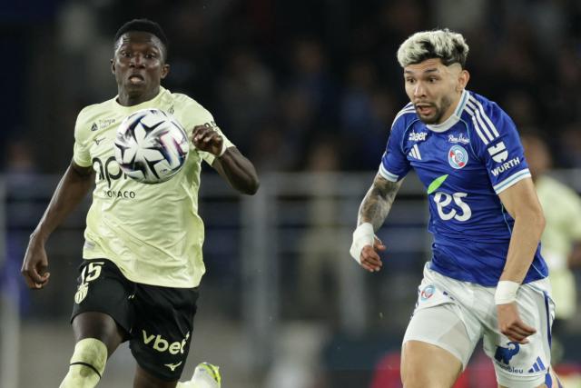 Monaco’s Senegalese midfielder #15 Lamine Camara (L) fights for the ball with Strasbourg’s Paraguayan midfielder #19 Julio Enciso during the French L1 football match between RC Strasbourg Alsace and AS Monaco at the Stade de la Meinau in Strasbourg, eastern France, on May 17, 2026. (Photo by ROMEO BOETZLE / AFP)