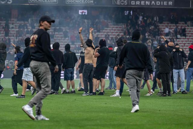 Nice supporters invade the pitch at the end of the French L1 football match between OGC Nice and FC Metz at the Allianz Riviera Stadium in Nice, south-eastern France, on May 17, 2026.  (Photo by MIGUEL MEDINA / AFP)