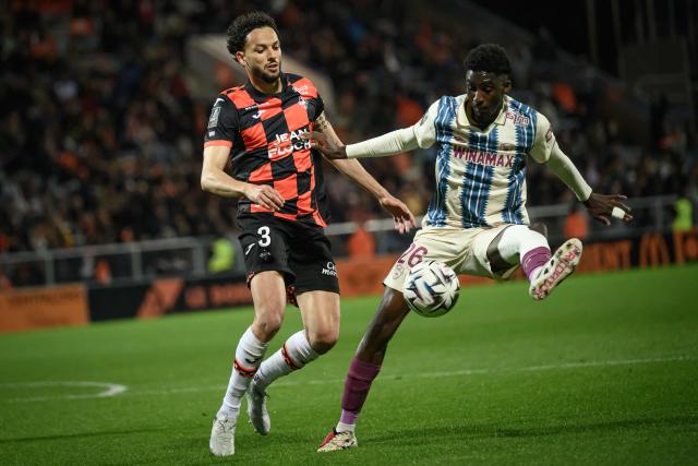 Lorient's Tunisian defender #03 Montassar Talbi (L) fights for the ball with Le Havre's Cameroonian midfielder #26 Simon Ebonog during the French L1 football match between FC Lorient and Le Havre AC at the Stade du Moustoir in Lorient, western France, on May 17, 2026. (Photo by Loic VENANCE / AFP)