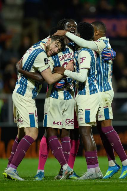(From L) Le Havre's French defender #04 Gautier Lloris (L) and teammates celebrate after winning the French L1 football match between FC Lorient and Le Havre AC at the Stade du Moustoir in Lorient, western France, on May 17, 2026. (Photo by Loic VENANCE / AFP)