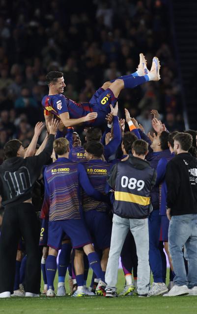 Barcelona's Polish forward #09 Robert Lewandowski is tossed in the air by teammates at the end of the Spanish league football match between FC Barcelona and Real Betis at the Camp Nou Stadium in Barcelona on May 17, 2026. Barcelona striker Robert Lewandowski said yesterday he is leaving the club this summer at the end of his contract. The veteran Polish forward, 37, scored 119 goals for Barcelona in 191 games across all competitions since joining from Bayern Munich in 2022. (Photo by JAIME REINA / AFP)