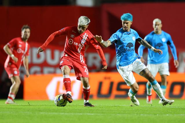 Argentinos Juniors' midfielder #21 Gabriel Florentin and Belgrano's midfielder #24 Emiliano Rigoni fight for the ball during the Argentine Professional Football League Apertura tournament semifinal match between Argentinos Juniors and Belgrano at the Diego Armando Maradona stadium in Buenos Aires on May 17, 2026. (Photo by Alejandro PAGNI / AFP)