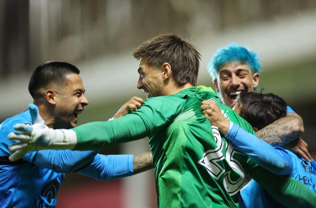 Belgrano players celebrate after winning the penalty shoot-out of the Argentine Professional Football League Apertura tournament semifinal match between Argentinos Juniors and Belgrano at the Diego Armando Maradona stadium in Buenos Aires on May 17, 2026. (Photo by Alejandro PAGNI / AFP)
