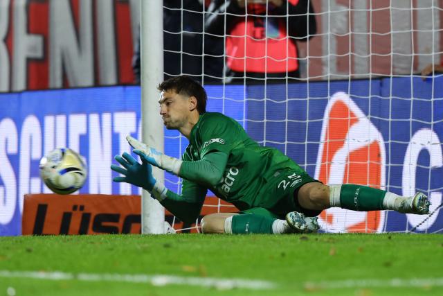 Belgrano's Uruguayan goalkeeper #25 Thiago Cardozostops a penalty to win the penalty shoot-out of the Argentine Professional Football League Apertura tournament semifinal match between Argentinos Juniors and Belgrano at the Diego Armando Maradona stadium in Buenos Aires on May 17, 2026. (Photo by Alejandro PAGNI / AFP)