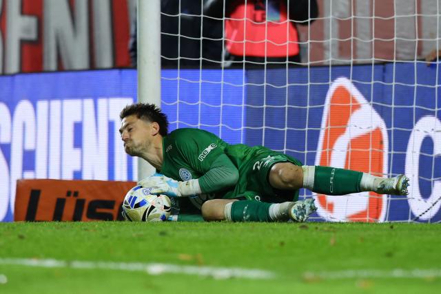Belgrano's Uruguayan goalkeeper #25 Thiago Cardozostops a penalty to win the penalty shoot-out of the Argentine Professional Football League Apertura tournament semifinal match between Argentinos Juniors and Belgrano at the Diego Armando Maradona stadium in Buenos Aires on May 17, 2026. (Photo by Alejandro PAGNI / AFP)
