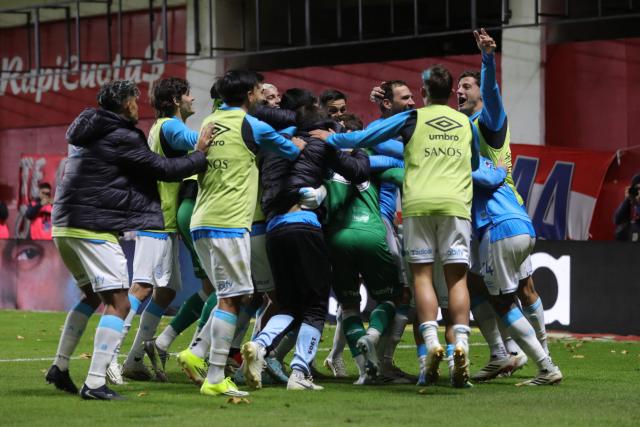 Belgrano players celebrate after winning the penalty shoot-out of the Argentine Professional Football League Apertura tournament semifinal match between Argentinos Juniors and Belgrano at the Diego Armando Maradona stadium in Buenos Aires on May 17, 2026. (Photo by Alejandro PAGNI / AFP)