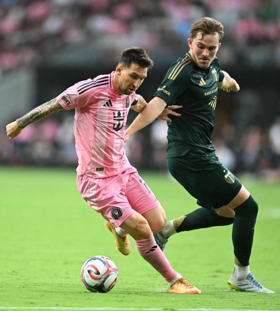 Inter Miami's Argentine forward #10 Lionel Messi (L) controls the ball under pressure from Portland Timber's US defender #23 Ian Smith during a Major League Soccer (MLS) regular season football match between Inter Miami CF and Portland Timbers at Nu Stadium in Miami, Florida, on May 17, 2026. (Photo by CHANDAN KHANNA / AFP)