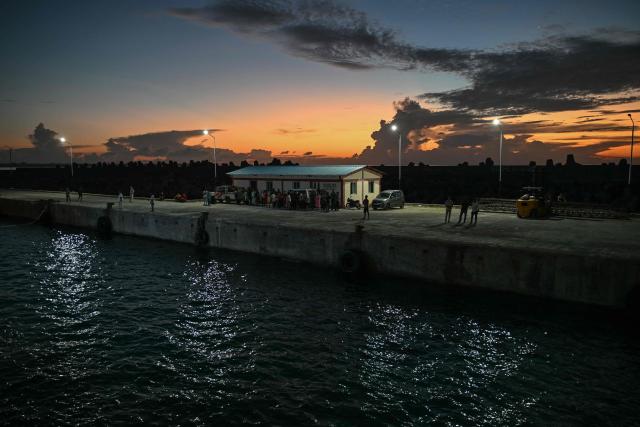 This photograph taken on March 30, 2026 shows people waiting to board a passenger ship at Mus Jetty in India's Andaman and Nicobar Islands. Running from the archipelago's capital Sri Vijayapuram in the north to the southern tip of Campbell Bay, the ferry serves as both a passenger and cargo ship. (Photo by R. Satish BABU / AFP) / To go with 'India-Andaman Nicobar-Economy-Shipping-Tourism' by Bhuvan BAGGA
