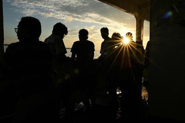 This photograph taken on March 30, 2026 shows passengers travelling on the MV Kalighat vessel plying across the waters of India's Andaman and Nicobar Islands. Running from the archipelago's capital Sri Vijayapuram in the north to the southern tip of Campbell Bay, the ferry serves as both a passenger and cargo ship. (Photo by R. Satish BABU / AFP) / To go with 'India-Andaman Nicobar-Economy-Shipping-Tourism' by Bhuvan BAGGA
