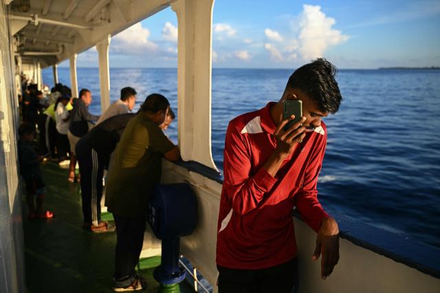 This photograph taken on March 30, 2026 shows passengers travelling on the MV Kalighat vessel plying across the waters of India's Andaman and Nicobar Islands. Running from the archipelago's capital Sri Vijayapuram in the north to the southern tip of Campbell Bay, the ferry serves as both a passenger and cargo ship. (Photo by R. Satish BABU / AFP) / To go with 'India-Andaman Nicobar-Economy-Shipping-Tourism' by Bhuvan BAGGA