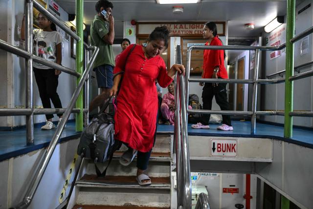 This photograph taken on March 30, 2026 shows passengers travelling on the MV Kalighat vessel plying across the waters of India's Andaman and Nicobar Islands. Running from the archipelago's capital Sri Vijayapuram in the north to the southern tip of Campbell Bay, the ferry serves as both a passenger and cargo ship. (Photo by R. Satish BABU / AFP) / To go with 'India-Andaman Nicobar-Economy-Shipping-Tourism' by Bhuvan BAGGA
