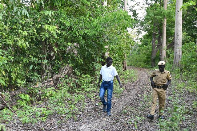 This photograph taken on March 22, 2026 shows members of the Onge tribal community who joined as police homeguards, patrolling in a forested area near the Hut Bay police station on Little Andaman island in India's Andaman and Nicobar Islands. Outsiders call the Indian Ocean island Little Andaman and its long-isolated guardians the Onge, but those preserving an age-old way of life now under threat have their own names. A $9 billion development plan across India's wider Andaman and Nicobar Islands will affect communities throughout the scattered archipelago. Authorities, treading a delicate line in managing contact, began last year recruiting more than 500 young men from communities across the archipelago as police "homeguards" to help manage relations with outsiders. (Photo by R. Satish BABU / AFP)