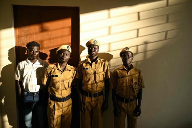 This photograph taken on March 22, 2026 shows (L-R) Tibilachu, Jhaj, Sagar and Raja,  members of the Onge tribal community who joined as police homeguards posing at the Hut Bay police station on Little Andaman island in India's Andaman and Nicobar Islands. Outsiders call the Indian Ocean island Little Andaman and its long-isolated guardians the Onge, but those preserving an age-old way of life now under threat have their own names. A $9 billion development plan across India's wider Andaman and Nicobar Islands will affect communities throughout the scattered archipelago. Authorities, treading a delicate line in managing contact, began last year recruiting more than 500 young men from communities across the archipelago as police "homeguards" to help manage relations with outsiders. (Photo by R. Satish BABU / AFP)