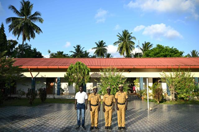 This photograph taken on March 22, 2026 shows (L-R) Tibilachu, Jhaj, Raja and Sagar,  members of the Onge tribal community who joined as police homeguards posing at the Hut Bay police station on Little Andaman island in India's Andaman and Nicobar Islands. Outsiders call the Indian Ocean island Little Andaman and its long-isolated guardians the Onge, but those preserving an age-old way of life now under threat have their own names. A $9 billion development plan across India's wider Andaman and Nicobar Islands will affect communities throughout the scattered archipelago. Authorities, treading a delicate line in managing contact, began last year recruiting more than 500 young men from communities across the archipelago as police "homeguards" to help manage relations with outsiders. (Photo by R. Satish BABU / AFP)