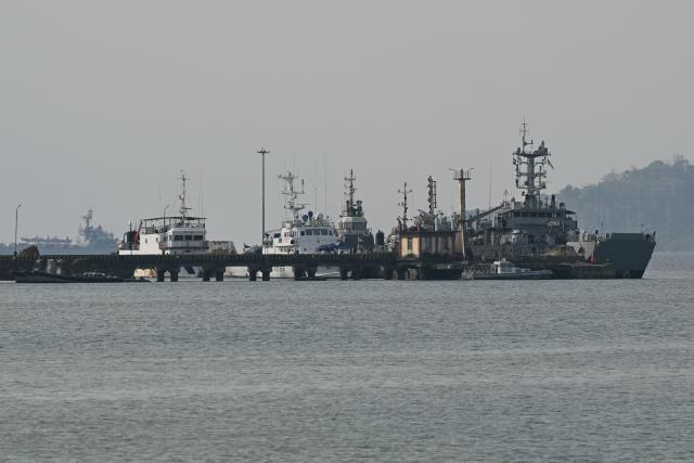 This photograph taken on March 28, 2026 shows ships docked near Campbell Bay at Great Nicobar island. One of the last outsiders to make authorised visits to India's only "uncontacted" tribe says it may be time to reconnect with the isolated people -- in order to shield them from an encroaching world. Anthropologist Anstice Justin, 71, took part in the government's limited contact missions to the restricted North Sentinel island in the Andaman Sea between 1986 and 2004. The island's inhabitants are famously resistant to engaging with outsiders, and even killed a US missionary who made an illegal visit in 2018. (Photo by R. Satish BABU / AFP)