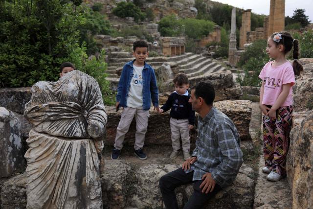 People visit the Sanctuary of Apollo at Cyrene near the ancient historical town of Shahat in the northeastern Mediterranean coast of Libya on May 17, 2026. Libya remains plagued by division and instability after years of unrest following the NATO-backed uprising that toppled longtime leader Muammar Gaddafi in 2011. Libya is still divided between the UN-recognised government in the west and its eastern rival in the east, backed by military commander Khalifa Haftar. (Photo by Abdullah DOMA / AFP)