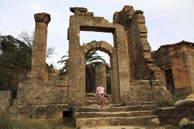 A girl visits the Sanctuary of Apollo at Cyrene near the ancient historical town of Shahat in the northeastern Mediterranean coast of Libya on May 17, 2026. Libya remains plagued by division and instability after years of unrest following the NATO-backed uprising that toppled longtime leader Muammar Gaddafi in 2011. Libya is still divided between the UN-recognised government in the west and its eastern rival in the east, backed by military commander Khalifa Haftar. (Photo by Abdullah DOMA / AFP)