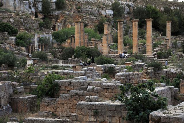 People visit the Sanctuary of Apollo at Cyrene near the ancient historical town of Shahat in the northeastern Mediterranean coast of Libya on May 17, 2026. Libya remains plagued by division and instability after years of unrest following the NATO-backed uprising that toppled longtime leader Muammar Gaddafi in 2011. Libya is still divided between the UN-recognised government in the west and its eastern rival in the east, backed by military commander Khalifa Haftar. (Photo by Abdullah DOMA / AFP)