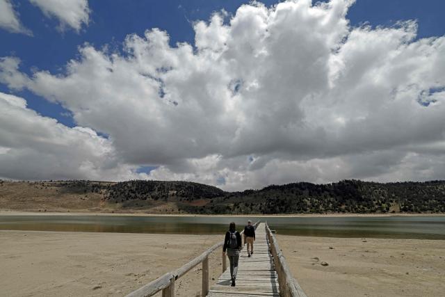 People visit the Lake Aguelmame Sidi Ali in the Khenifra province of Morocco on May 17, 2026. (Photo by Abdel Majid BZIOUAT / AFP)