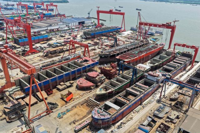 This aerial photo shows a view of ships under construction at a ship building facility in Yangzhou, in China’s eastern Jiangsu province on May 17, 2026. (Photo by CN-STR / AFP) / China OUT