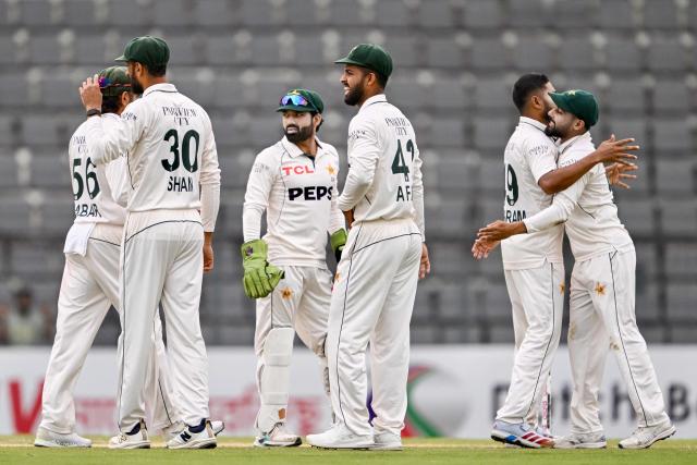 Pakistan’s players celebrate after the dismissal of Bangladesh’s Najmul Hossain Shanto during the third day of the second Test cricket match between Bangladesh and Pakistan at the Sylhet International Cricket Stadium in Sylhet on May 18, 2026. (Photo by Munir UZ ZAMAN / AFP)