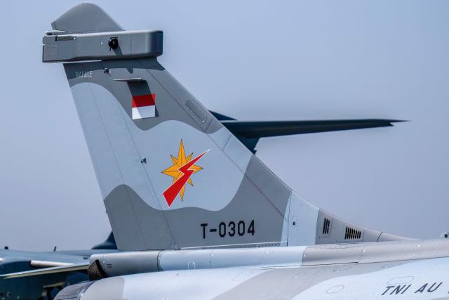 The logo of the Indonesian Air Force's (TNI AU) Air Squadron 3 (The Dragon) is seen on the tail of a Rafale jet fighter during a ceremony to hand over six new Rafale jet fighters, six Dassault Falcon 8X aircrafts and two Airbus A400M Atlas transport planes to the Indonesian Air Force at Halim Perdanakusuma Air Force Base in Jakarta on May 18, 2026. (Photo by BAY ISMOYO / AFP)