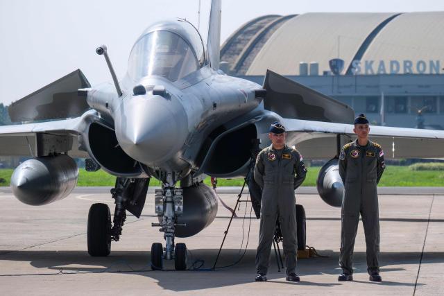 Fighter pilots stand during a ceremony to hand over six new Rafale jet fighters, six Dassault Falcon 8X aircrafts and two Airbus A400M Atlas transport planes to the Indonesian Air Force at Halim Perdanakusuma Air Force Base in Jakarta on May 18, 2026. (Photo by BAY ISMOYO / AFP)
