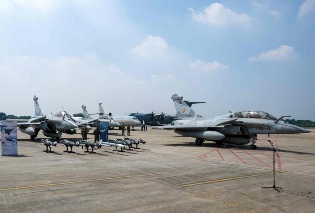 Fighter pilots stand near aircrafts during a ceremony to hand over six new Rafale jet fighters, six Dassault Falcon 8X aircrafts and two Airbus A400M Atlas transport planes to the Indonesian Air Force at Halim Perdanakusuma Air Force Base in Jakarta on May 18, 2026. (Photo by BAY ISMOYO / AFP)