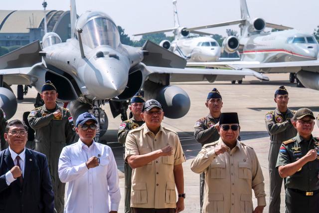 Indonesian President Prabowo Subianto (front, 3rd R) poses for a photo with high-ranking officials during a ceremony to hand over six new Rafale jet fighters, six Dassault Falcon 8X aircrafts and two Airbus A400M Atlas transport planes to the Indonesian Air Force at Halim Perdanakusuma Air Force Base in Jakarta on May 18, 2026. (Photo by BAY ISMOYO / AFP)