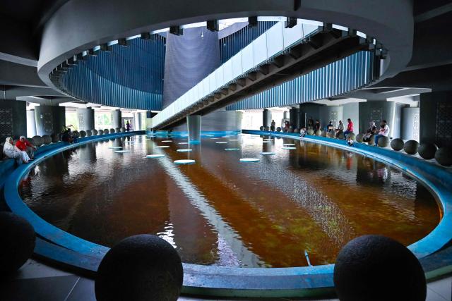 People visit the Aceh Tsunami Museum on International Museum Day in Banda Aceh on May 18, 2026. (Photo by CHAIDEER MAHYUDDIN / AFP)