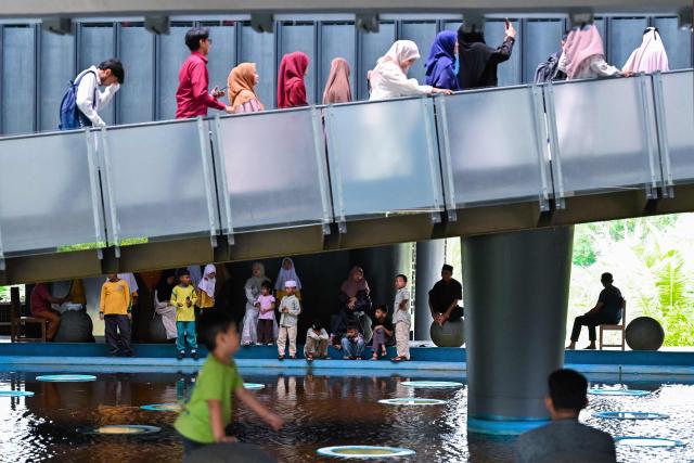 People visit the Aceh Tsunami Museum on International Museum Day in Banda Aceh on May 18, 2026. (Photo by CHAIDEER MAHYUDDIN / AFP)
