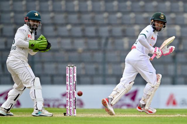 Bangladesh’s Mushfiqur Rahim (R) watches the ball after playing a shot as Pakistan’s wicketkeeper Muhammad Rizwan fields during the third day of the second Test cricket match between Bangladesh and Pakistan at the Sylhet International Cricket Stadium in Sylhet on May 18, 2026. (Photo by Munir UZ ZAMAN / AFP)