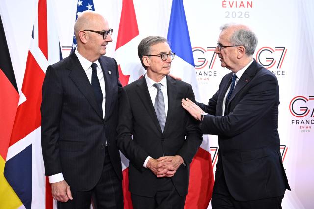 France's Economy, Finances and Industry Minister Roland Lescure (L) and Governor of the Bank of France François Villeroy de Galhau (R) greet Governor of the Bank of Canada Tiff Macklem prior to a meeting of G7 Finance Ministers and Central Bank Governors in preparation for the summit of heads of State and government to be held in June 2026 in Evian, in Paris on May 18, 2026. (Photo by JULIEN DE ROSA / AFP)