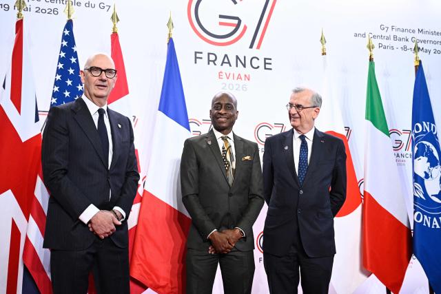 France's Economy, Finances and Industry Minister Roland Lescure (L) and Governor of the Bank of France François Villeroy de Galhau (R) greet US Vice Chair of the Federal Reserve Philip Jefferson prior to a meeting of G7 Finance Ministers and Central Bank Governors in preparation for the summit of heads of State and government to be held in June 2026 in Evian, in Paris on May 18, 2026. (Photo by JULIEN DE ROSA / AFP)