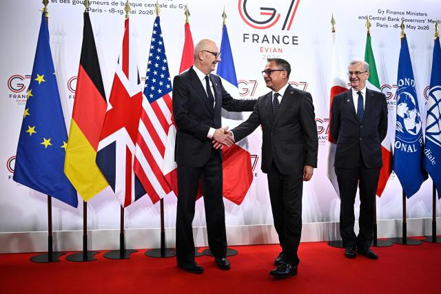 France's Economy, Finances and Industry Minister Roland Lescure (L) and Governor of the Bank of France François Villeroy de Galhau (R) greet President of the German Bundesbank Joachim Nagel prior to a meeting of G7 Finance Ministers and Central Bank Governors in preparation for the summit of heads of State and government to be held in June 2026 in Evian, in Paris on May 18, 2026. (Photo by JULIEN DE ROSA / AFP)