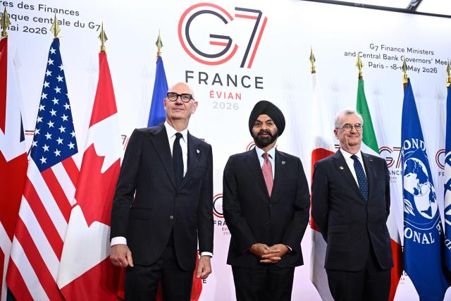 France's Economy, Finances and Industry Minister Roland Lescure (L) and Governor of the Bank of France François Villeroy de Galhau (R) greet President of the World Bank Group Ajay Banga prior to a meeting of G7 Finance Ministers and Central Bank Governors in preparation for the summit of heads of State and government to be held in June 2026 in Evian, in Paris on May 18, 2026. (Photo by JULIEN DE ROSA / AFP)